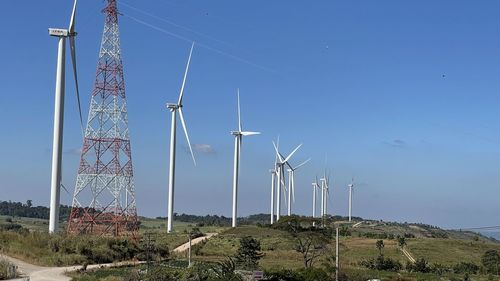 Low angle view of electricity pylon against clear sky