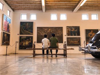 Rear view of people standing on table