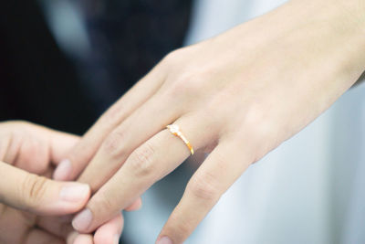 Cropped groom holding groom hand