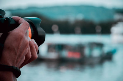 Close-up of man hand holding camera