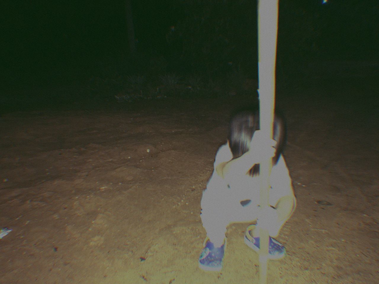 LOW SECTION OF BOY PLAYING WITH SHADOW ON FLOOR