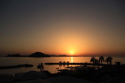Scenic view of sea against orange sky