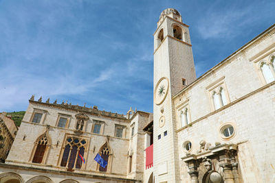 Low angle view of clock tower against sky in city