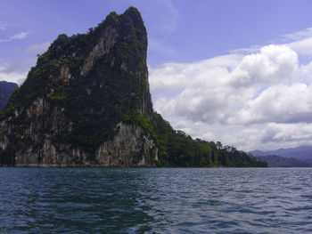 Scenic view of sea and mountains against sky