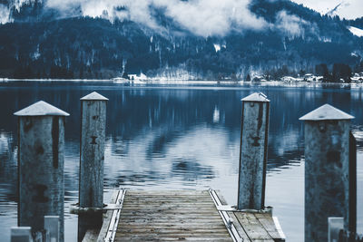 Wooden posts on pier over lake