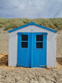 Built structure on beach against sky