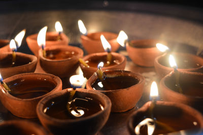 A plate is which is loaded with rose and candle on indian festival diwali deepawali with fire