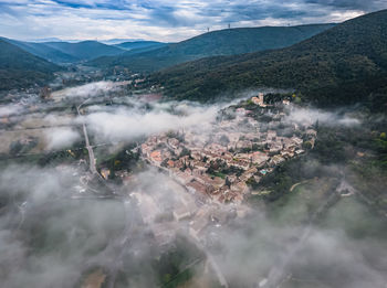 Panoramic view of the old village of mirmande. aerial photo in the morning in the thick fog rising 