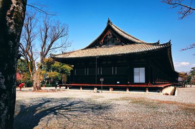 Exterior of building by trees against sky