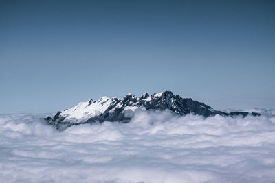 Scenic view of snowcapped mountains against clear blue sky