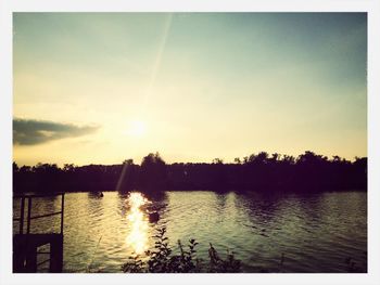 Scenic view of lake at sunset