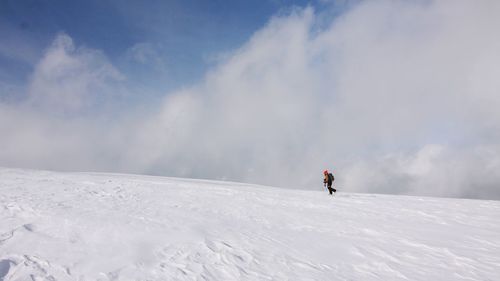 People walking on snow covered landscape