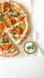 High angle view of food on table, vegan buffalo cauliflower pizza with green onions, artisan pizza