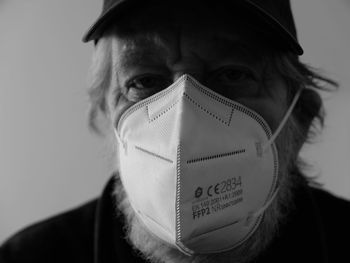 Close-up portrait of senior man wearing protective face mask