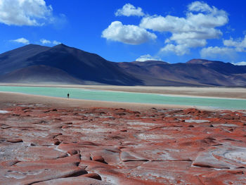 Scenic view of landscape and mountains against blue sky