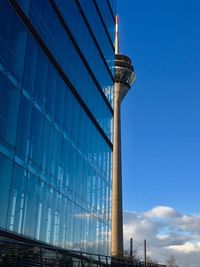 Low angle view of modern building against blue sky