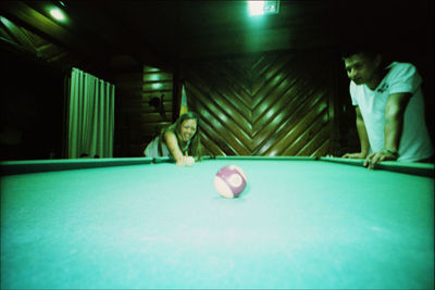 People playing with ball on table