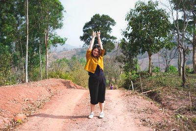 Young asian woman feeling happy and relax in the field.