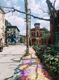 Street amidst buildings against sky