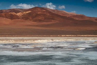 Scenic view of sea and mountains against sky