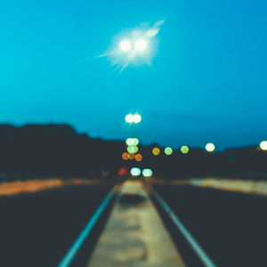 View of illuminated road at night