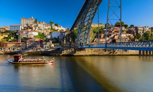 Boats in river with city in background