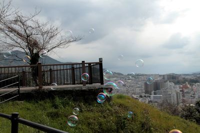 High angle view of bubbles in park against sky