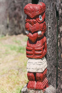 Close-up of sculpture on tree trunk in field