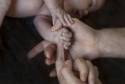 High angle view of family holding hands