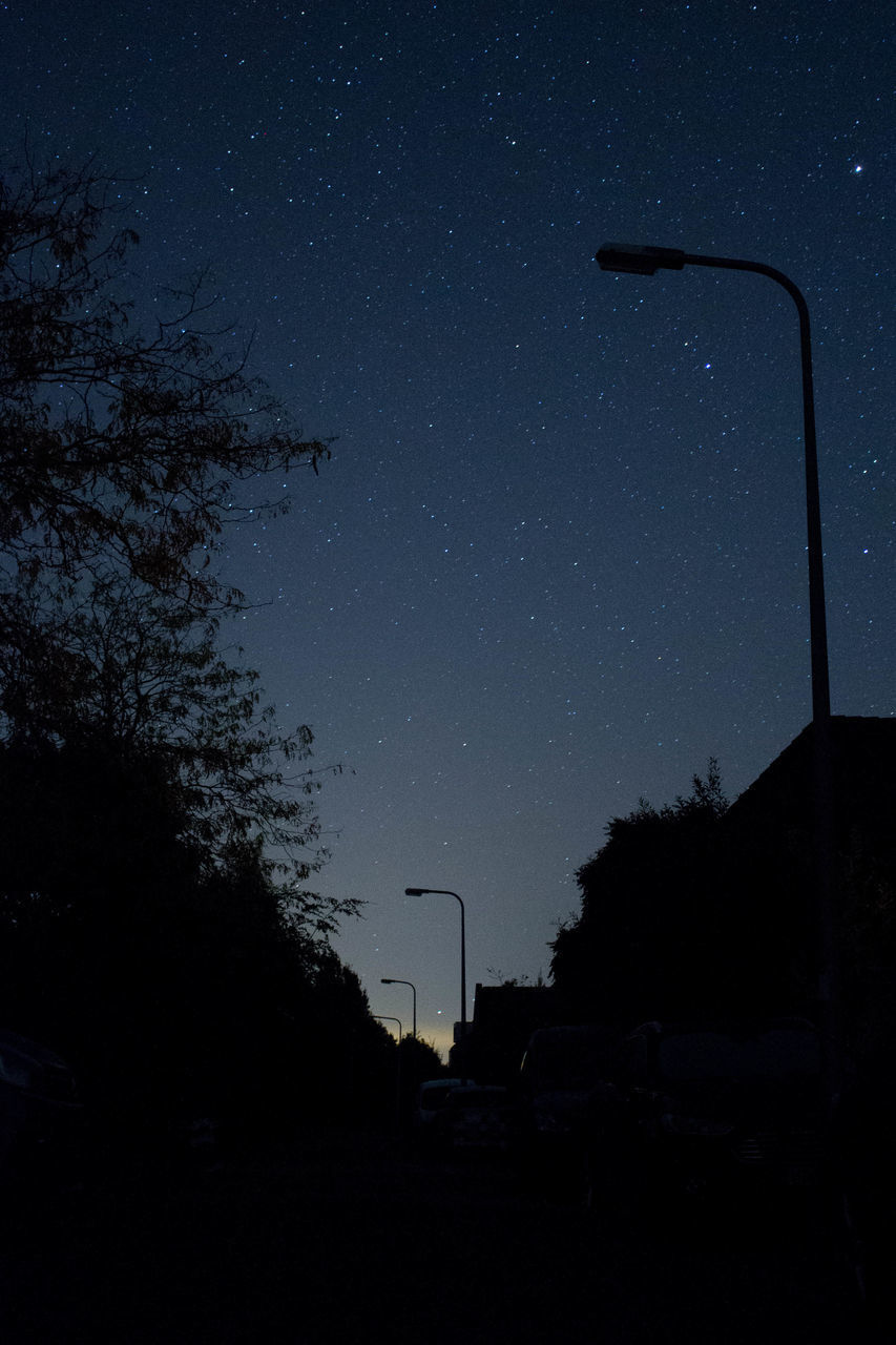 LOW ANGLE VIEW OF STREET LIGHTS AGAINST SKY AT NIGHT