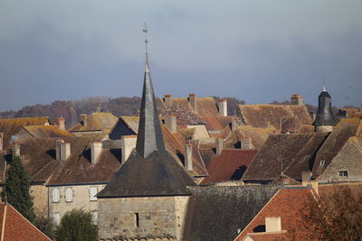 Buildings in town against sky