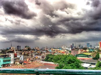 Buildings against cloudy sky