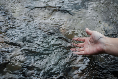 High angle view of hand over sea