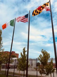 Low angle view of flags flag against sky