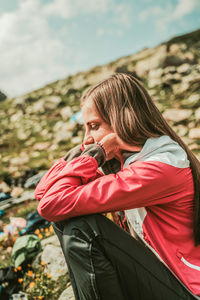 Woman looking away while standing outdoors