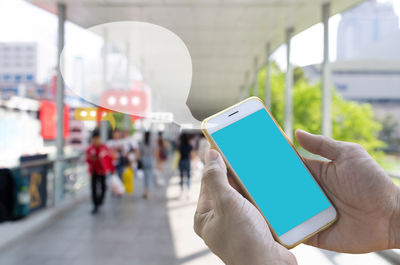 Midsection of man using mobile phone in bus