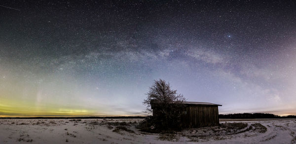 Scenic view of snow field against sky at night