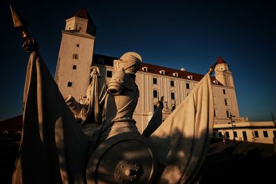 Low angle view of sculptures on building against clear sky