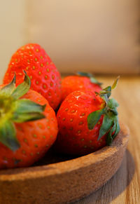 Close-up of strawberries in basket on table