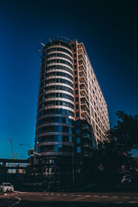 Low angle view of illuminated building against sky at night