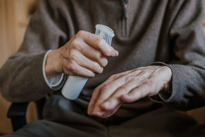 Midsection of man using mobile phone