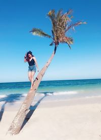 Full length of woman on beach against sky