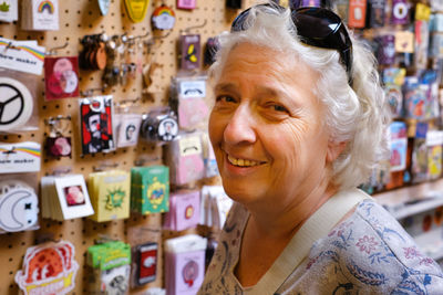 Portrait of a beautiful gray-haired seventy-year-old woman in a souvenir shop. person