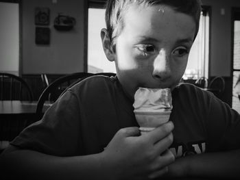 Boy eating ice cream in restaurant