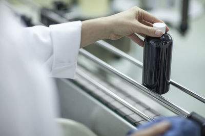 Worker with flask in medical factory