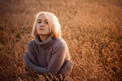 Portrait of woman by plants in farm