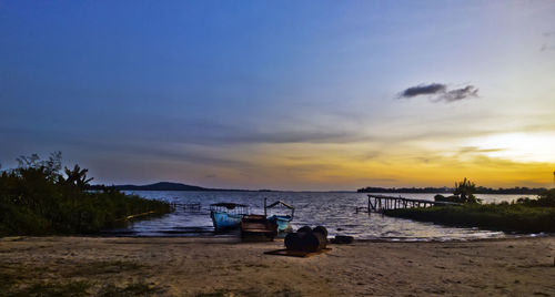 Scenic view of beach against sky during sunset
