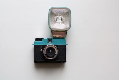 Close-up of camera over white background