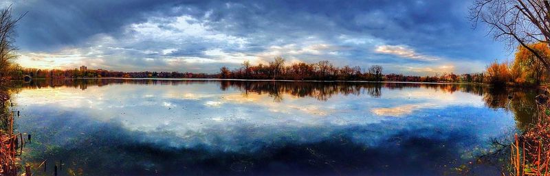 Scenic view of lake against cloudy sky