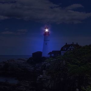 Low angle view of lighthouse against sky at sunset